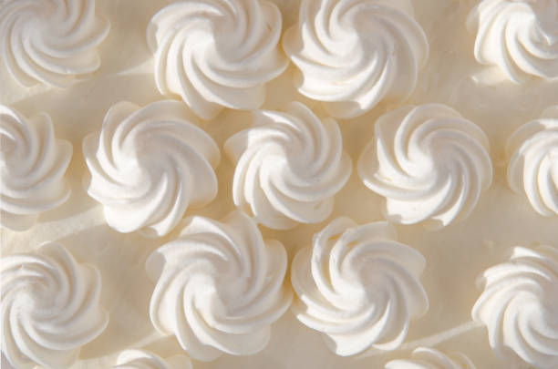 istock White cream on cake in the sun. Background, texture 933140720