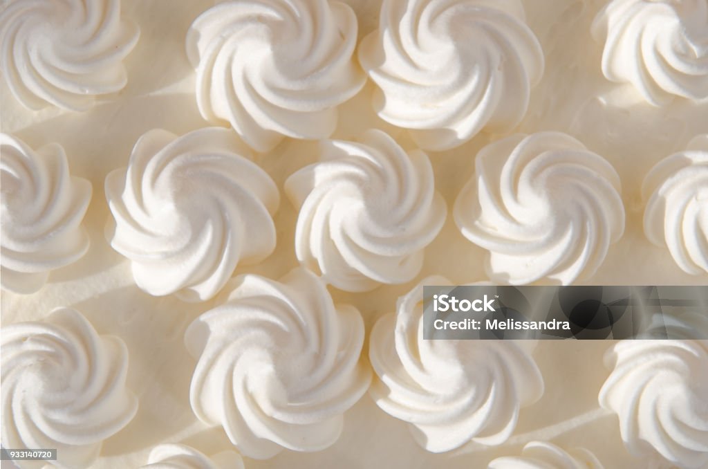 White cream on cake in the sun. Background, texture White cream on a cake in the sun. Background, texture Icing Stock Photo