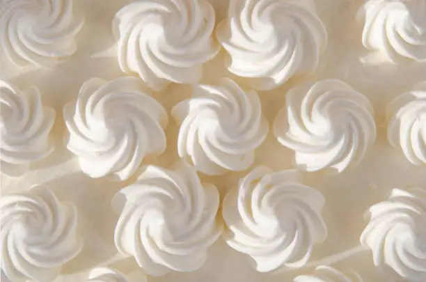 White cream on a cake in the sun. Background, texture