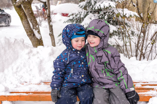 Young 8 year old boy and 7 year old girl enjoying the snow