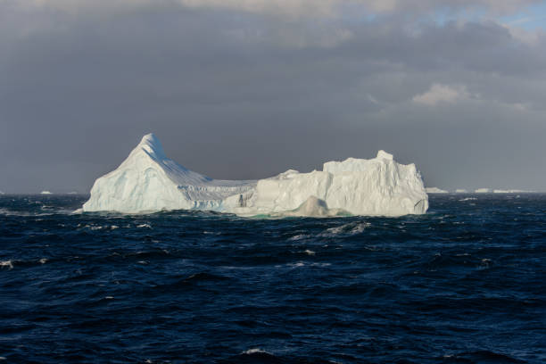 istock Iceberg in wavy sea 933141452