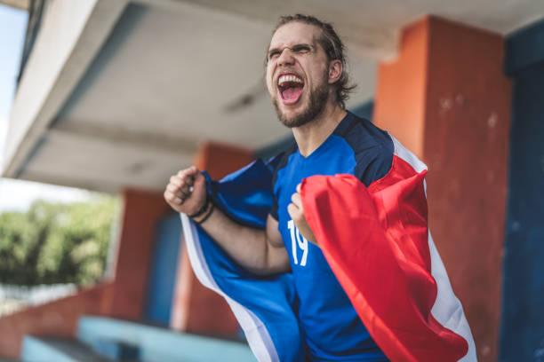 istock French fan watching a soccer game 933143860