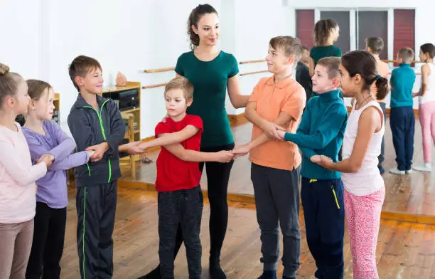 Photo of children  studying folk style dance in class