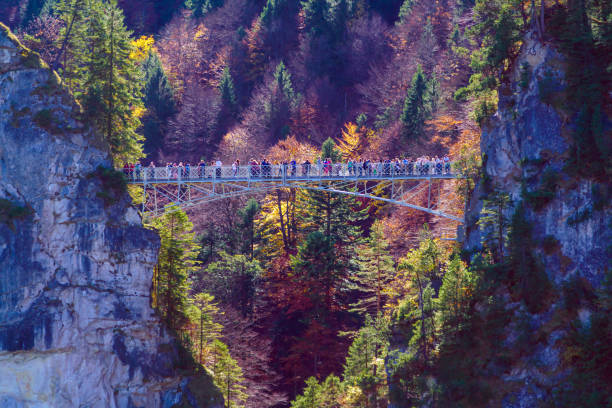 観光客が marienbruecke (マリーの橋) の上に立つ - neuschwanstein ストックフォトと画像