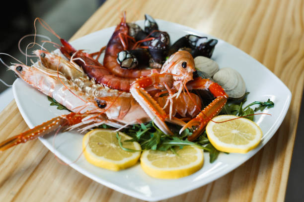 istock Prawns, langoustines and clams on white plate 933154322