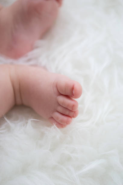istock baby feet on white blanket. copy space. selective focus 933156994