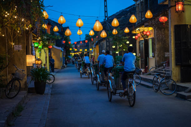 Night view of busy street in Hoi An, Vietnam. stock photo