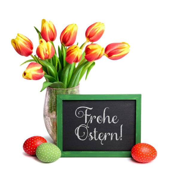 istock Bunch of red tulips with yellow tops, chalk board and colored Easter eggs on white, text 933166426
