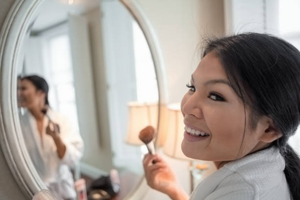 istock Asian woman applying make-up 933169194