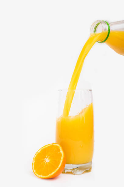 istock Pouring orange juice on white background. 933172896