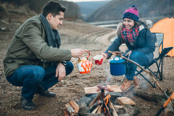 istock Campers next to the campfire preparing food 933175176