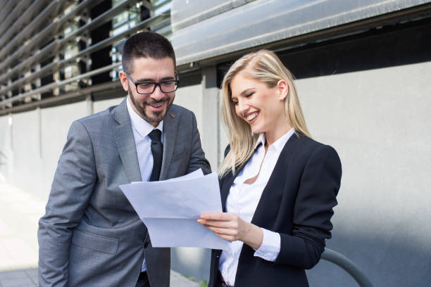 istock Two young business people analyze the results and discuss 933175264