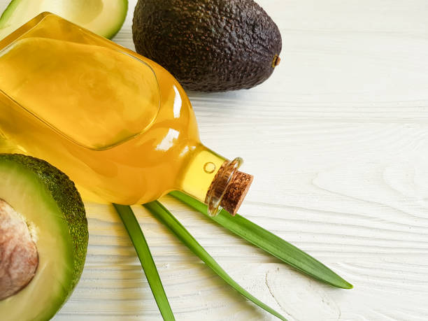 istock avocado oil on white wooden background 933175322
