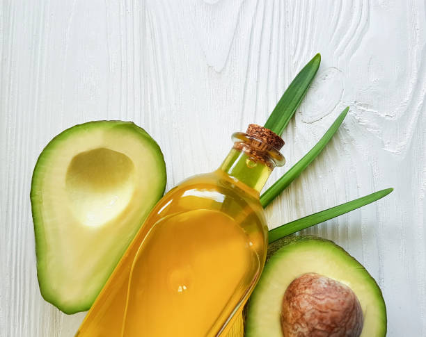 istock avocado oil on white wooden background 933175818
