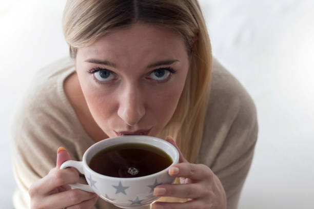 Three Young Woman Drinking Coffee in Cafe and Having Fun