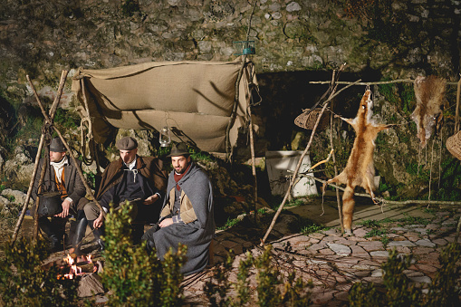 Rasiglia (Foligno), Italy - January, 2018. Hunters camping during a living Christmas Nativity scene reenactment. Landscape format.