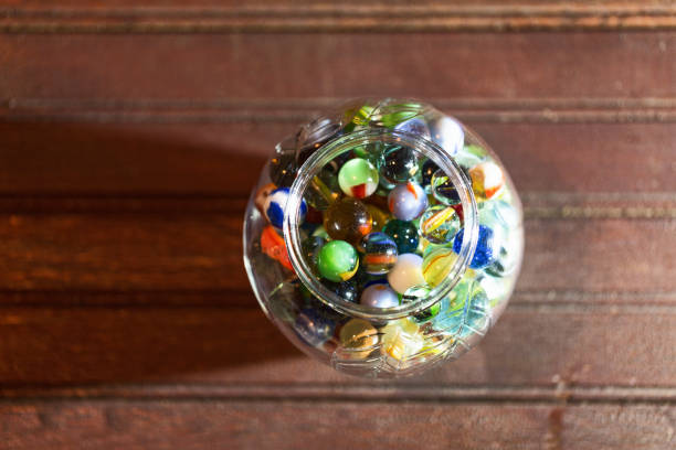 Close-up image of a collection of vintage glass marbles in a jar.