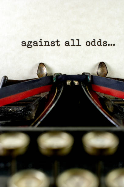 istock Antique typewriter with saying against all odds 933210980