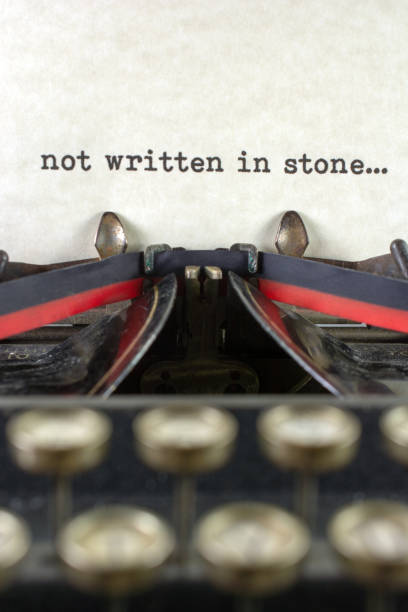 istock Antique typewriter with saying playing written in stone 933214724