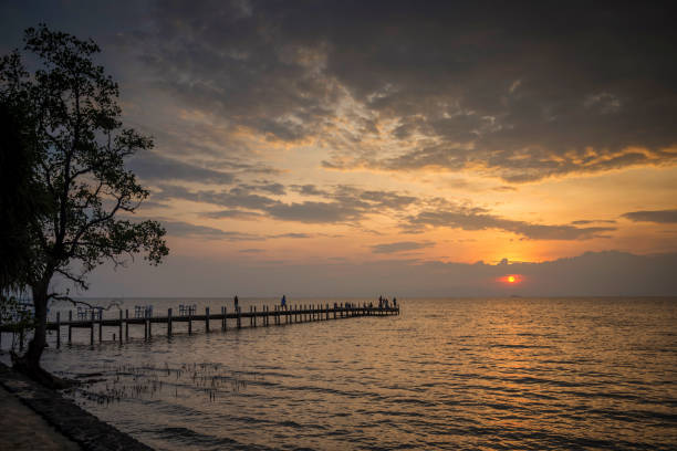 sunset and pier view in kep on cambodia coast sunset and pier view in kep on cambodia coast kep stock pictures, royalty-free photos & images