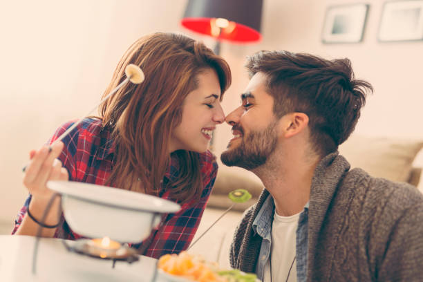 istock Couple dipping fruit into melted chocolate 933232828