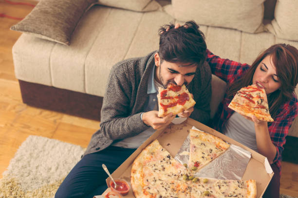 istock Couple eating pizza for lunch 933232848
