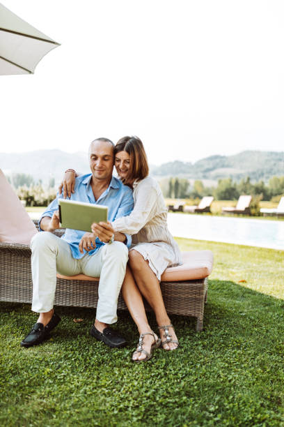 istock happiness couple using the tablet on the garden 933237040