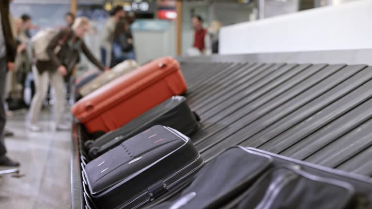 LD Travel bags moving around on the baggage carousel in the baggage claim area at the airport