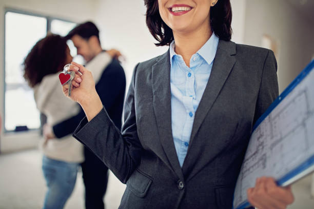 istock Real estate agent is holding key for a new apartment 933240142