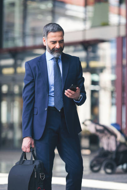 istock Senior businessman outdoors using smart phone 933241848