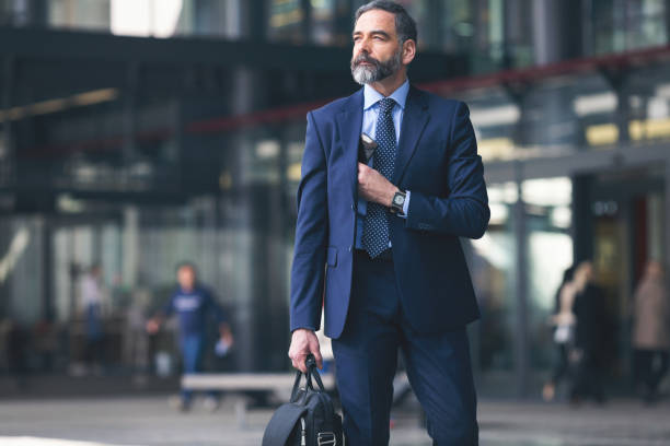 istock Senior businessman outdoors using smart phone 933241922