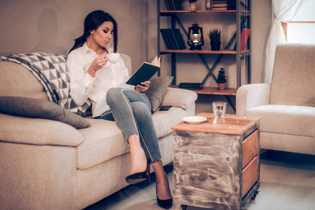 istock Young woman resting of work with book 933274430