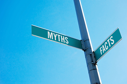 Road sign symbolizing decision between Myths and facts