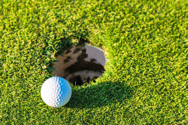 istock Close-up of golf ball on grass 933302556