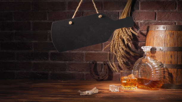 istock Glass of cognac with barrel on brick backgroun 933312436