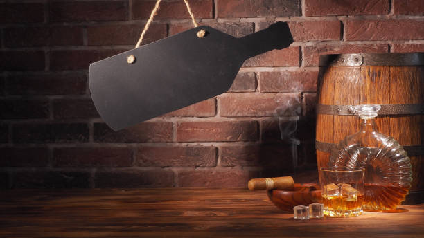 istock Glass of cognac with barrel on brick backgroun 933312736