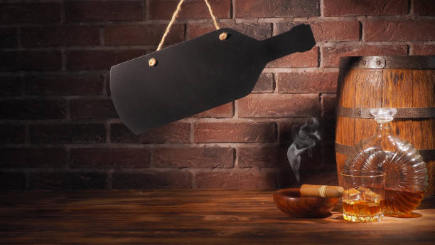 istock Glass of cognac with barrel on brick backgroun 933312844