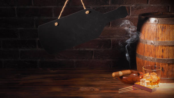 istock Glass of cognac with barrel on brick backgroun 933312936