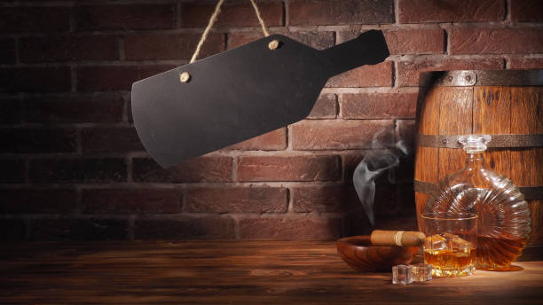 istock Glass of cognac with barrel on brick backgroun 933314436
