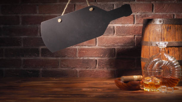 istock Glass of cognac with barrel on brick backgroun 933315034
