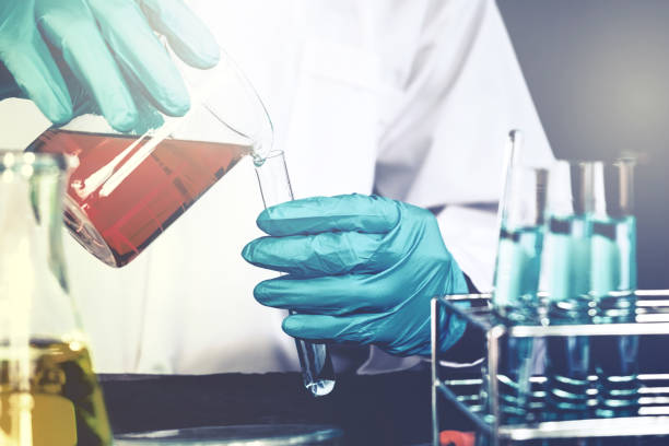 istock Scientist with equipment holding tools during scientific experiment science concept 933321008