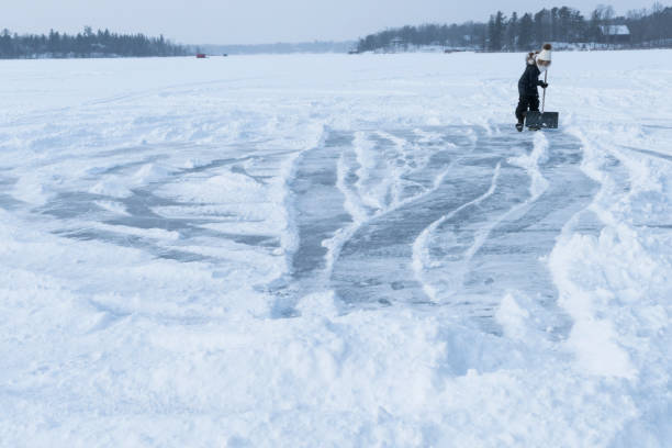 istock Creating an ice skating area on a frozen lake 933326024