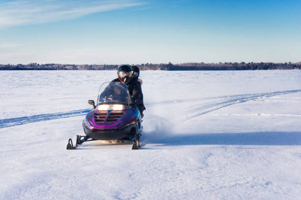 the skid marks of snowmobile on the frozen river, sunny day shot