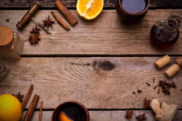 Christmas mulled wine with ingredients on wooden table. Top view with space for text.