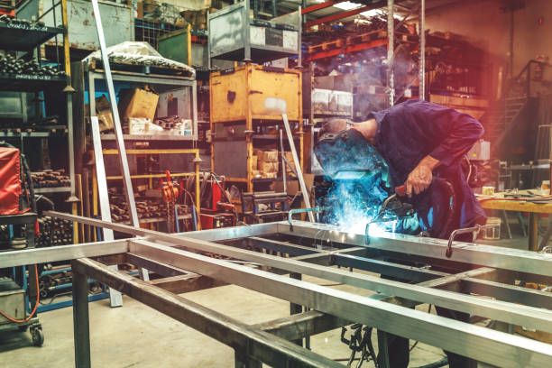 istock Young Metal Worker Welding In Factory With Protective Equipment 933344820