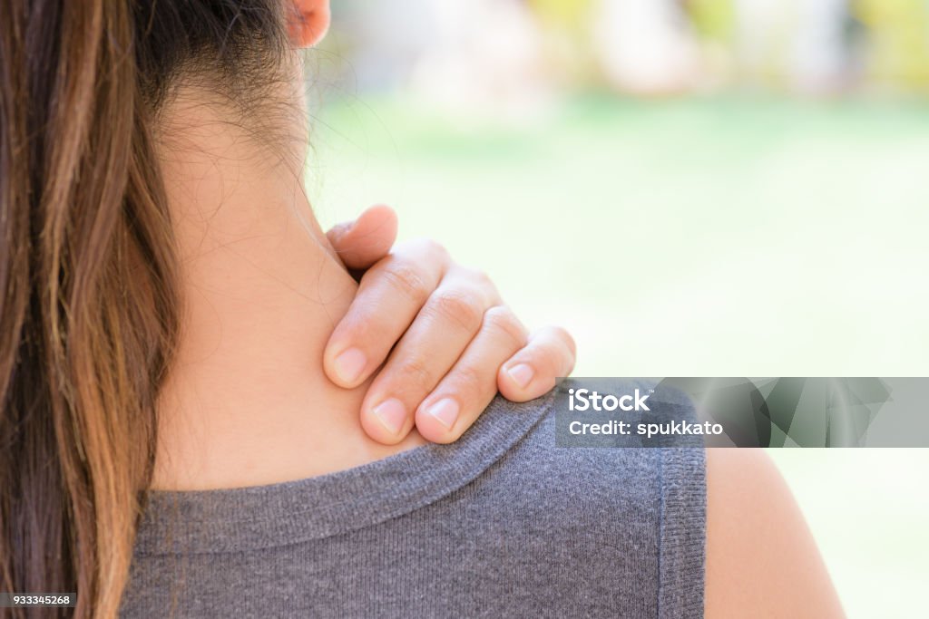 Closeup woman neck and shoulder pain and injury. Health care and medical concept. Neck Stock Photo