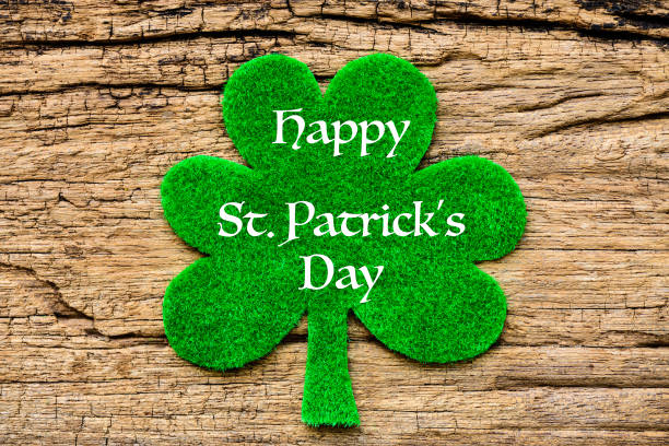 istock Happy St Patricks Day message with green clover leaf on wooden background 933347410