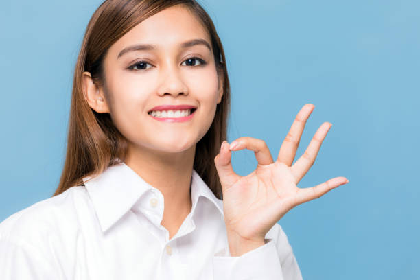 istock Young woman showing OK hand sign. 933347492