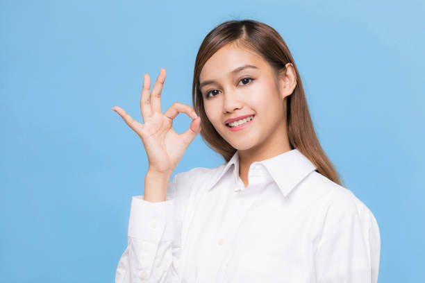 Young woman showing OK hand sign.