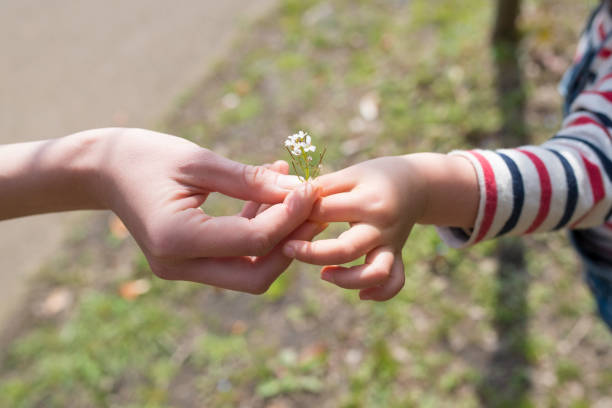 istock Parent and child handing flower 933362942